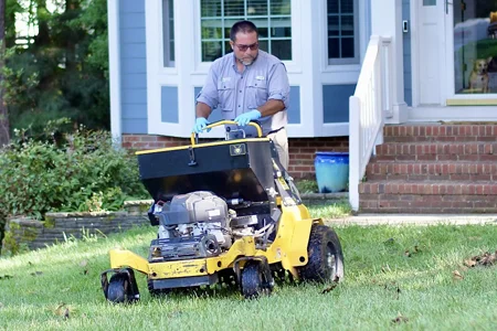 Triangle Lawn technician aerating front lawn