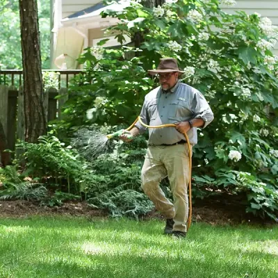 Tech spraying lawn