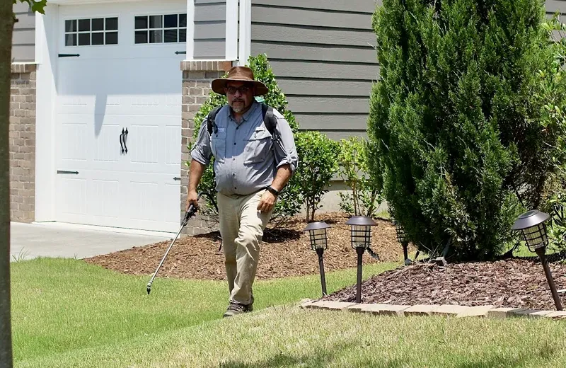 Service technician spraying weeds